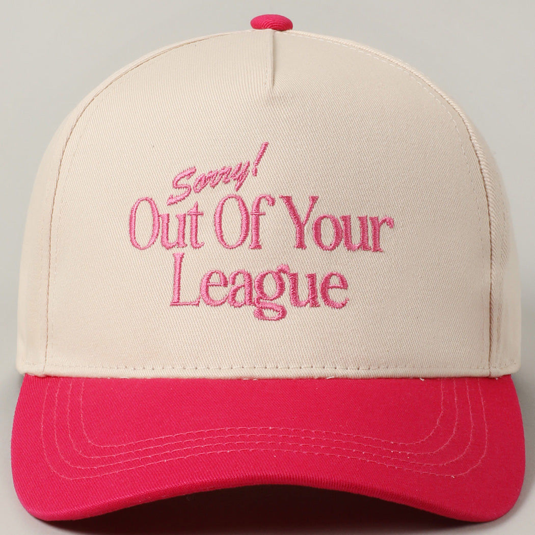 Front view of beige and fuchsia trucker hat with Sorry! Out Of Your League quote in pink thread