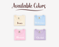 Four folded shirts in Ivory, Hydrangea, Blossom, and Orchid colors with color names printed on them.