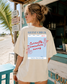 Woman wearing a t-shirt with a graphic design on the beach